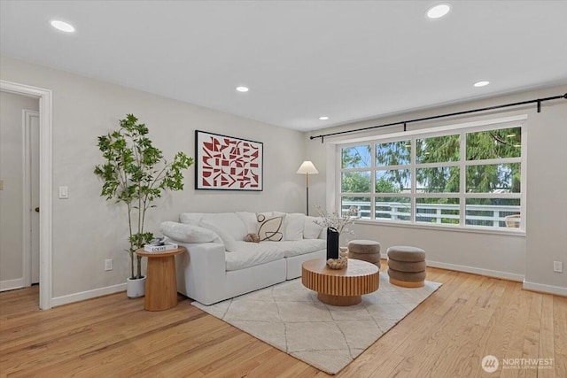 living area featuring recessed lighting, baseboards, and wood finished floors