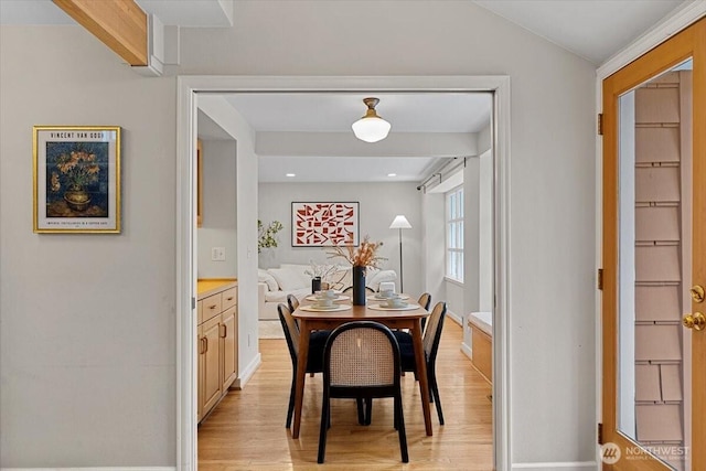 dining room with recessed lighting, light wood-style flooring, and lofted ceiling