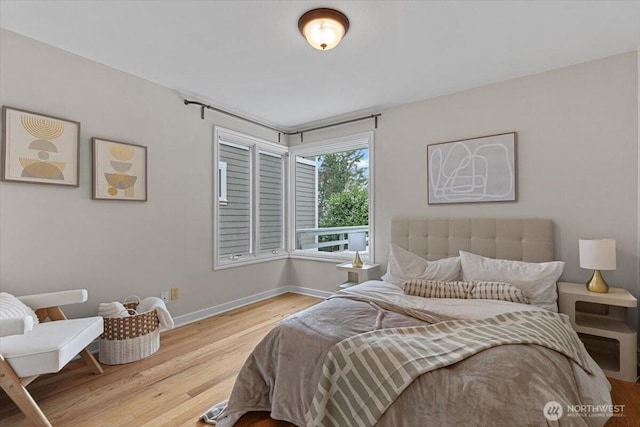 bedroom featuring wood finished floors and baseboards