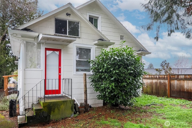 view of front of home featuring fence