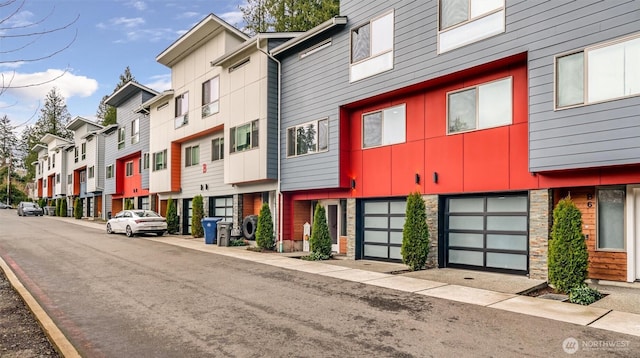 view of building exterior featuring a residential view and an attached garage