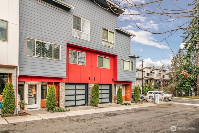 multi unit property featuring a residential view and a garage