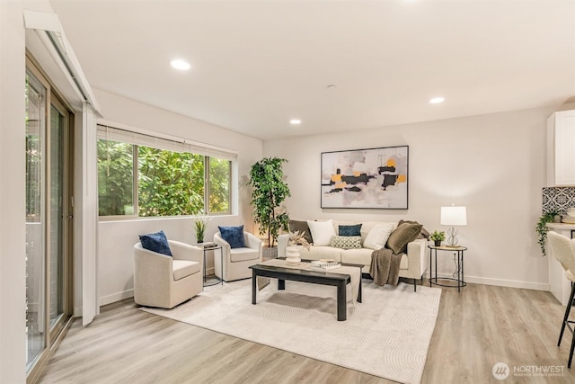 living area featuring recessed lighting, light wood-style flooring, and baseboards