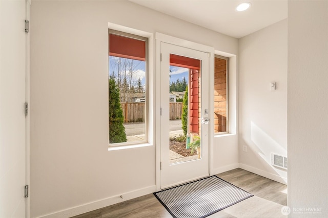 entryway featuring recessed lighting, visible vents, baseboards, and wood finished floors