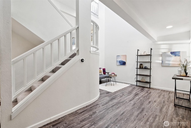 interior space with recessed lighting, wood finished floors, and baseboards