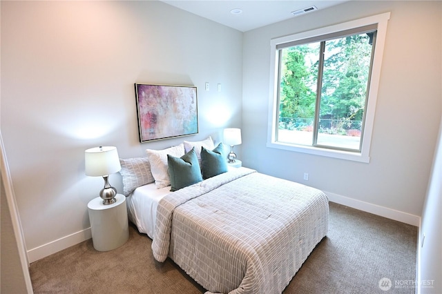 bedroom with baseboards, visible vents, and carpet floors