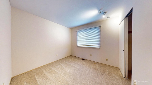 unfurnished bedroom with light colored carpet and visible vents