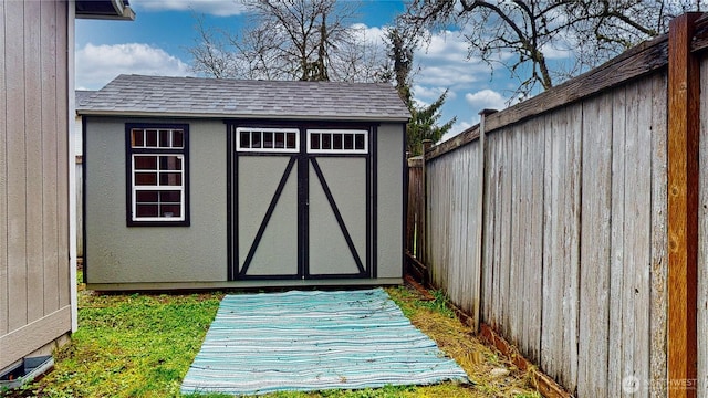 view of shed with a fenced backyard