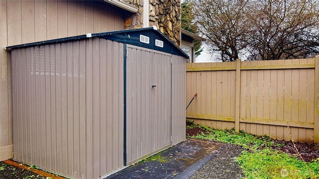 view of shed with a fenced backyard