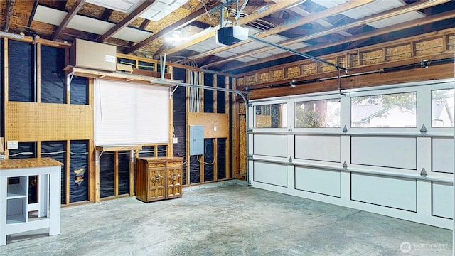 garage with electric panel and a garage door opener