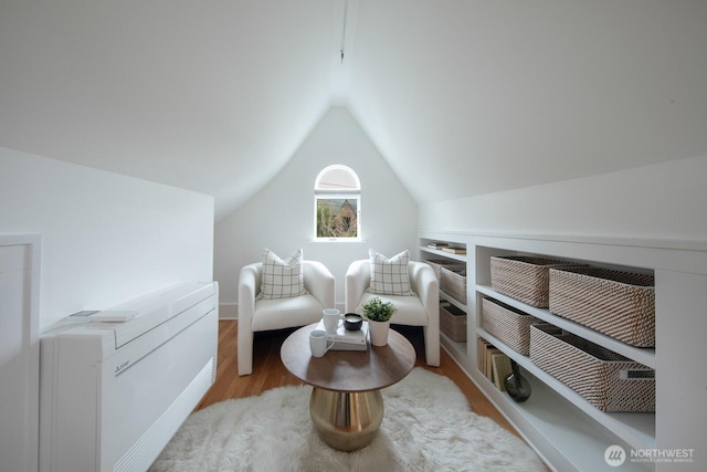 sitting room featuring lofted ceiling and wood finished floors