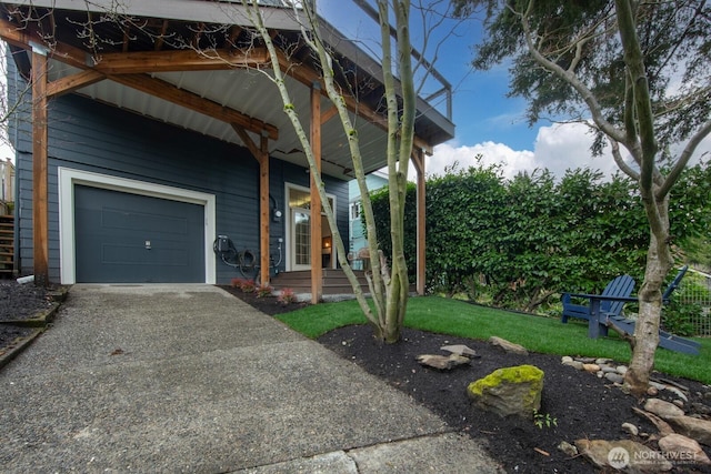 view of front of property with gravel driveway, a front lawn, a garage, and covered porch