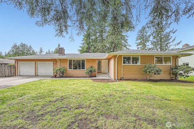 ranch-style house featuring fence, driveway, an attached garage, a front lawn, and board and batten siding