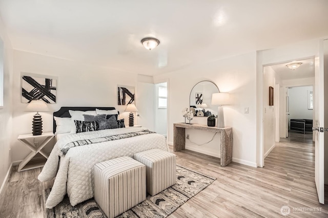 bedroom featuring baseboards and light wood-style floors