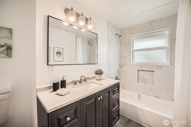 bathroom featuring vanity, toilet, and bathtub / shower combination