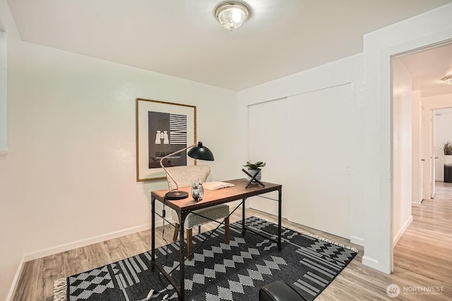 office space featuring baseboards and light wood-style floors