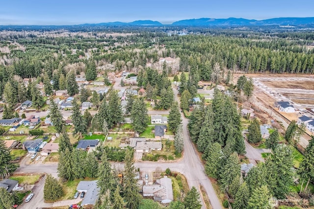 birds eye view of property with a view of trees and a mountain view