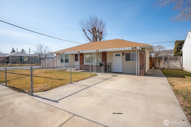 view of front facade with a fenced front yard, brick siding, covered porch, and a front lawn