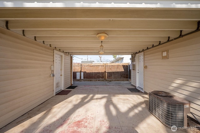 view of patio / terrace with central air condition unit and fence