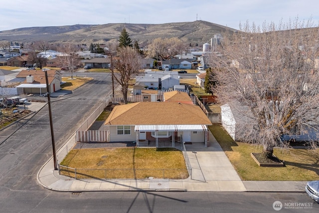 drone / aerial view featuring a residential view and a mountain view