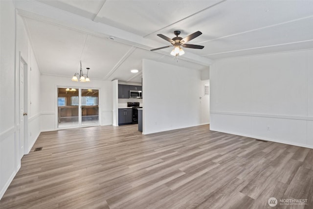 unfurnished living room with lofted ceiling with beams, ceiling fan with notable chandelier, visible vents, and light wood finished floors