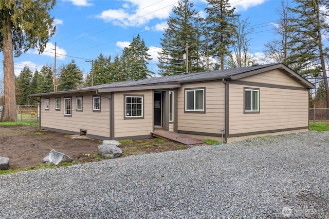 ranch-style home with fence