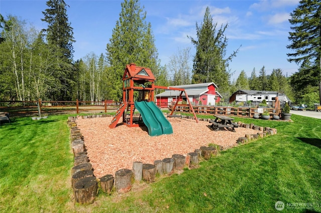 view of play area with fence and a lawn