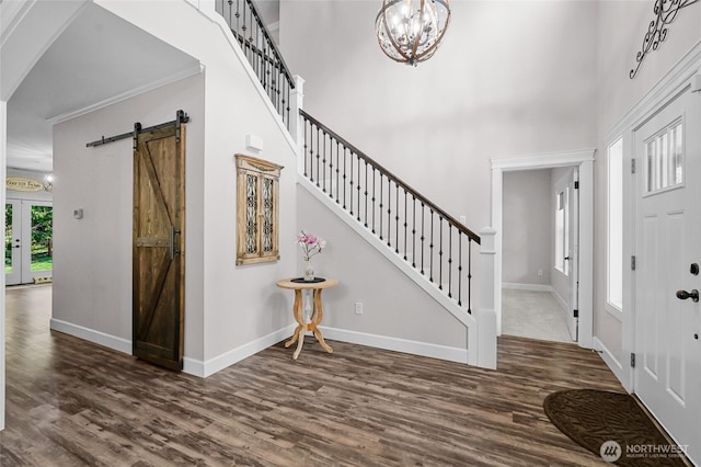 foyer with baseboards and wood finished floors