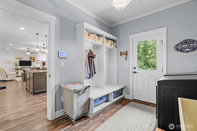 mudroom featuring washer / clothes dryer, crown molding, wood finished floors, baseboards, and ceiling fan with notable chandelier