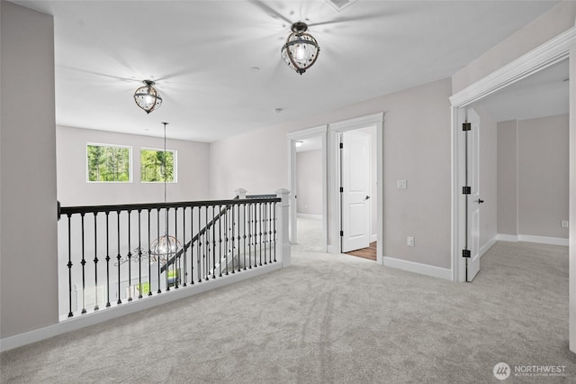 spare room featuring carpet floors and baseboards