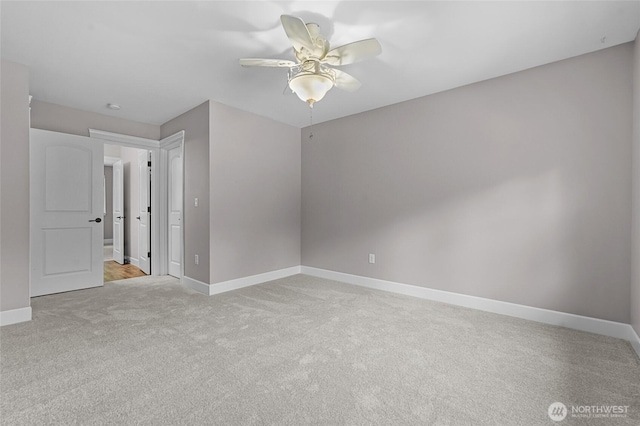 unfurnished bedroom featuring baseboards, a ceiling fan, and light colored carpet