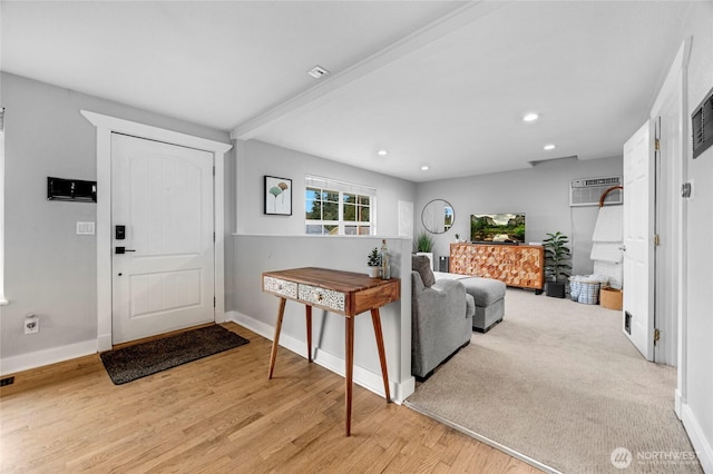 foyer entrance with baseboards, visible vents, beam ceiling, recessed lighting, and light wood-style floors