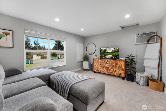 living room featuring carpet, baseboards, attic access, recessed lighting, and an AC wall unit