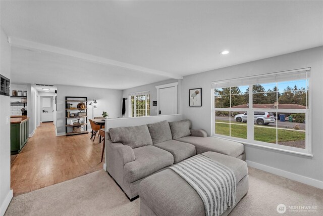 living area featuring light wood-style flooring, recessed lighting, and baseboards