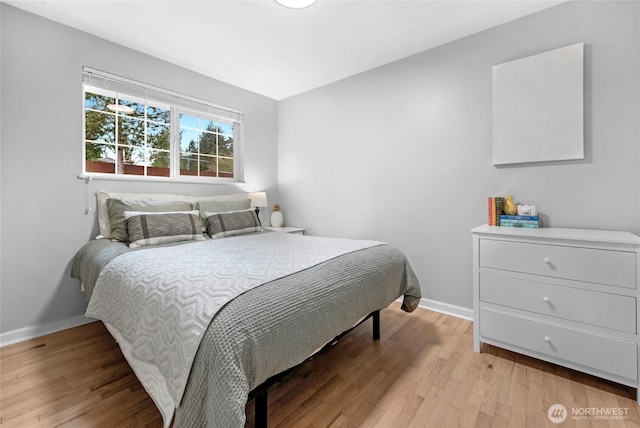 bedroom featuring light wood-style flooring and baseboards