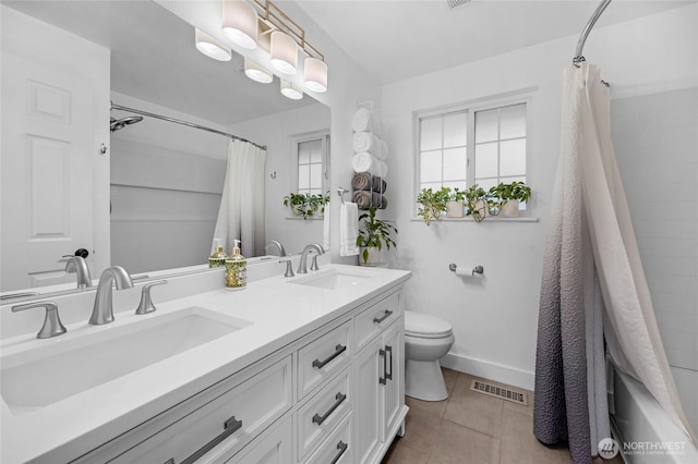 bathroom with tile patterned floors, visible vents, toilet, and a sink