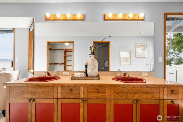 full bath featuring double vanity and a sink