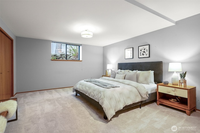 bedroom featuring a closet, baseboards, and carpet