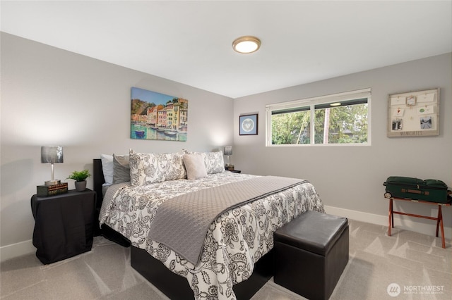 bedroom with baseboards and light carpet