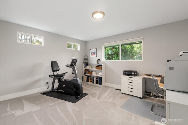 exercise room with carpet flooring and baseboards