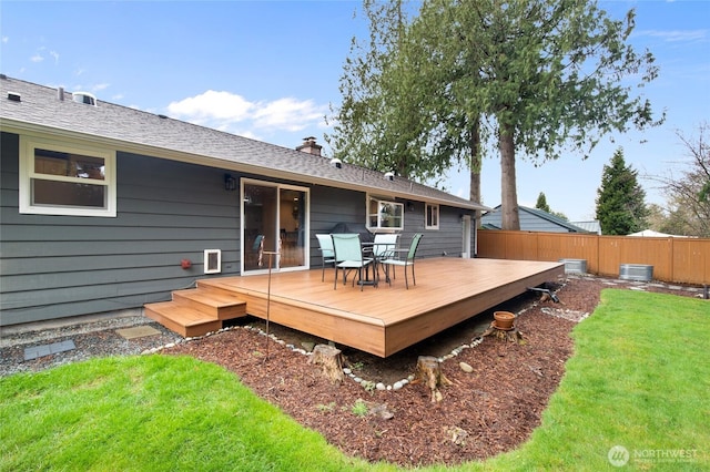 wooden deck featuring a yard and fence