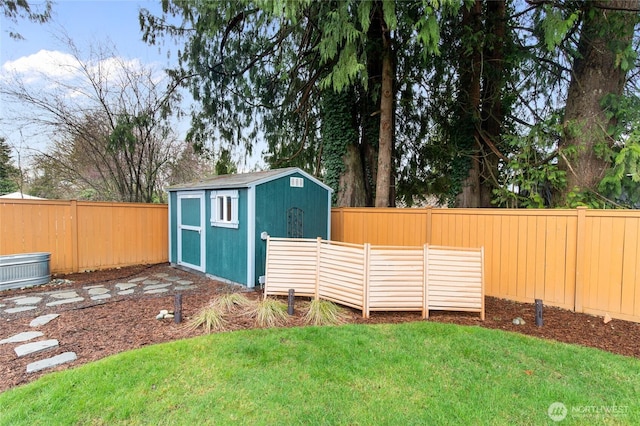 view of yard with an outbuilding, a fenced backyard, and a shed