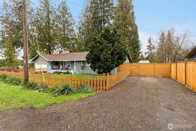 view of yard featuring a fenced front yard and a gate