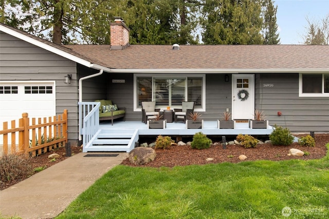 view of front of house featuring outdoor lounge area, roof with shingles, a chimney, and fence