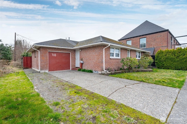 view of side of home with driveway, brick siding, an attached garage, and a lawn