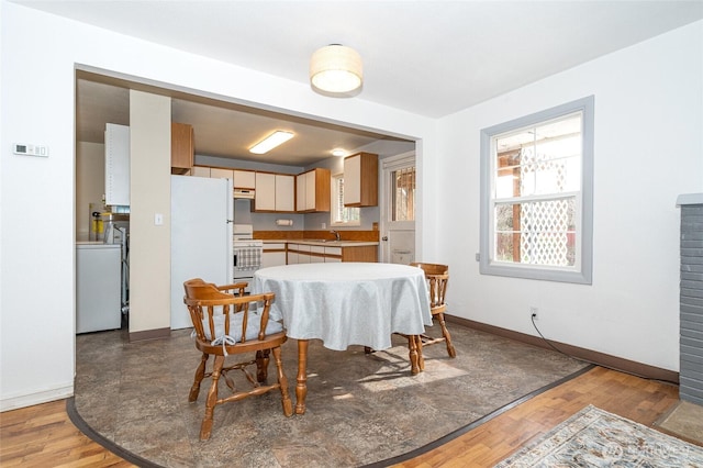 dining area featuring wood finished floors and baseboards