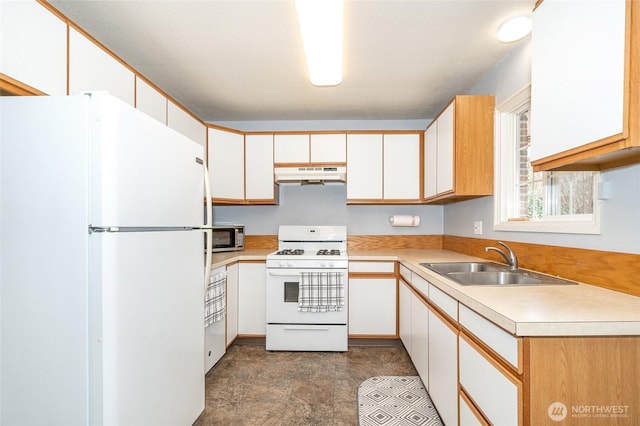 kitchen with under cabinet range hood, light countertops, white cabinets, white appliances, and a sink