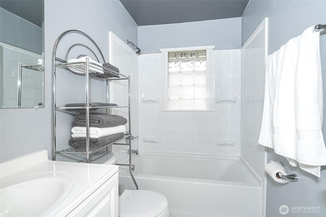 bathroom with toilet, vanity, and shower / tub combination