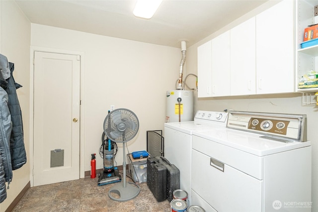 clothes washing area featuring water heater, independent washer and dryer, and cabinet space