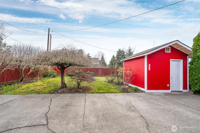 exterior space featuring an outdoor structure and fence private yard